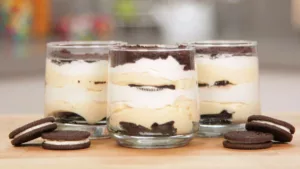 Indulge in the Creamy Delight of Oreo Tiramisu! 🍪😋 Ingredients: • 2 cups heavy whipping cream • 8 oz mascarpone cheese • 1/2 cup powdered sugar • 1 tsp vanilla extract • 1 cup brewed espresso, cooled • 1/4 cup coffee liqueur (optional) • 24 Oreo cookies • Cocoa powder for dusting • Chocolate shavings for garnish Directions: . In a mixing bowl, whip the heavy cream until stiff peaks form. . In a separate bowl, blend mascarpone cheese, powdered sugar, and vanilla extract until smooth. . Gently fold the whipped cream into the mascarpone mixture until well combined. . In a shallow dish, combine brewed espresso and coffee liqueur (if using). . Quickly dip each Oreo into the coffee mixture and layer them in the bottom of a serving dish. . Spread a layer of the mascarpone mixture on top of the Oreo layer. . Repeat the layers until all ingredients are used, finishing with a layer of mascarpone mixture. . Refrigerate for at least 4 hours or overnight to allow the flavors to meld. . Just before serving, dust the top with cocoa powder and garnish with chocolate shavings. Enjoy your luscious Oreo Tiramisu!